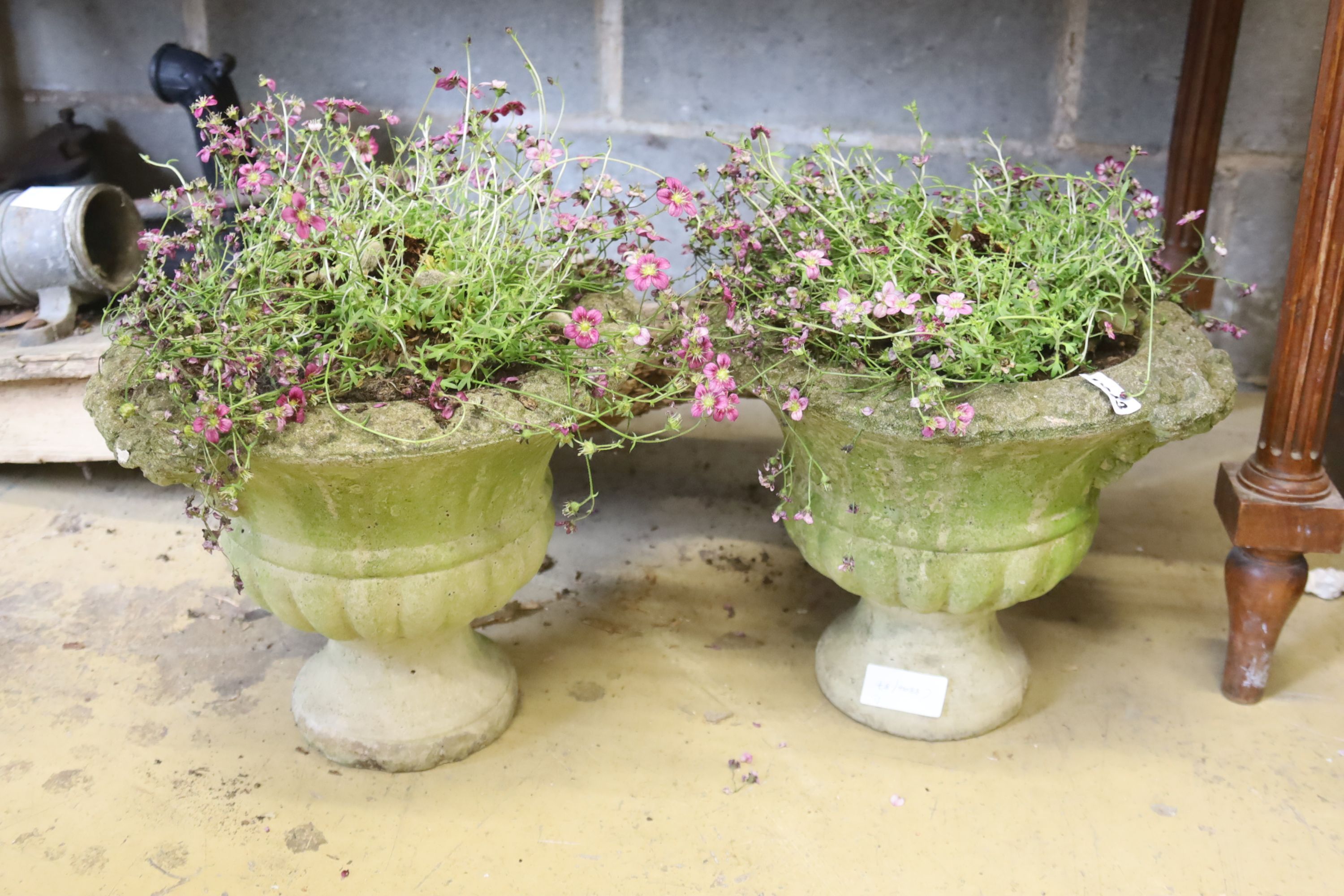 A pair of reconstituted garden planters, 30cm diameter, height 26cm